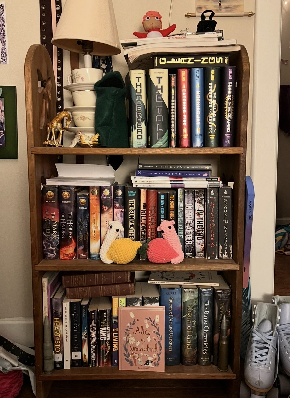 Bookshelf with many books and two cute crochet snails