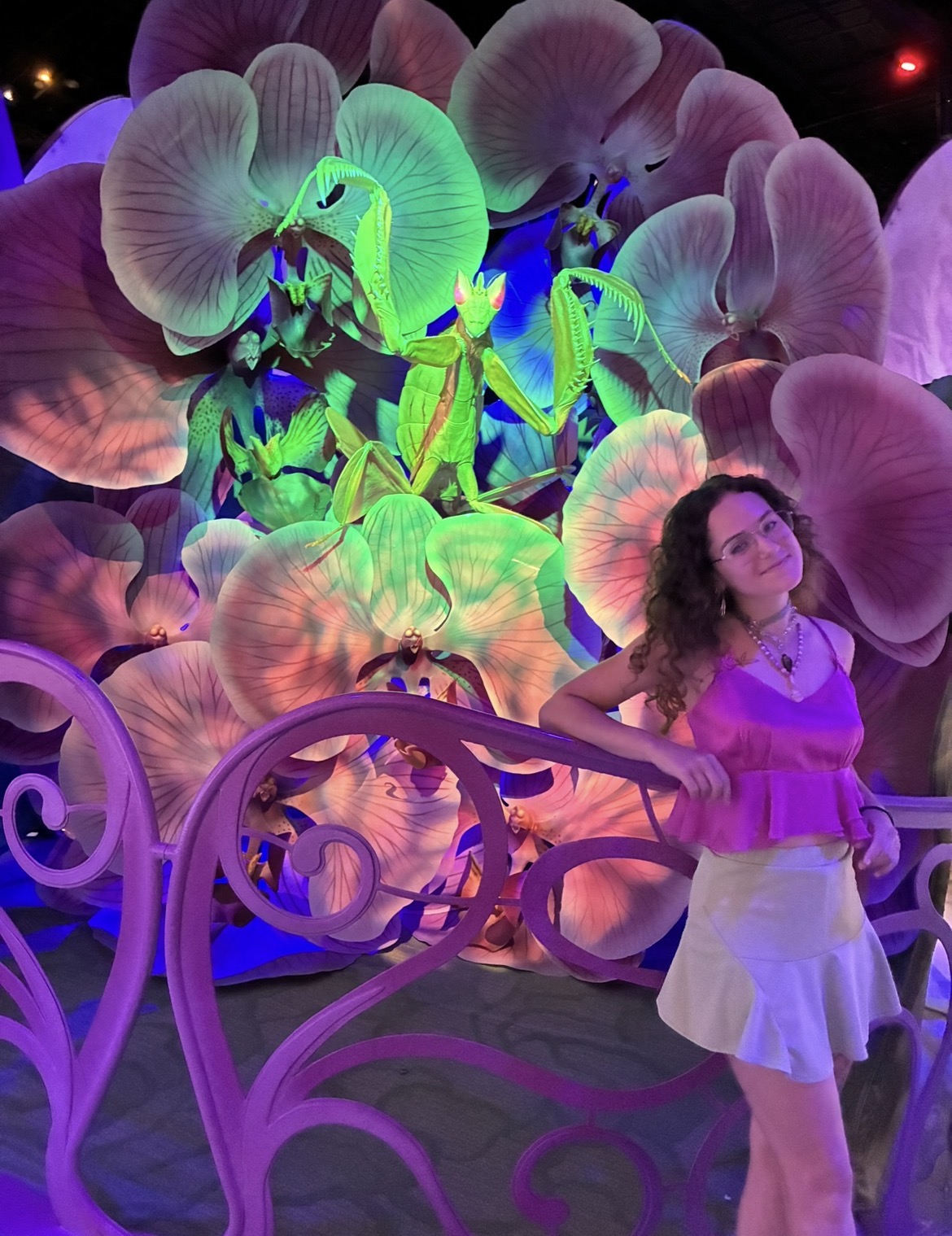 Angelica posing in front of a colorful praying mantis